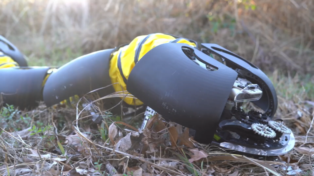 Robotic Snake In Grassy Terrain Featuring Gears And Yellow Accents